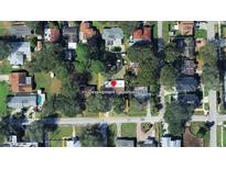 Aerial view of the property surrounded by mature trees in a residential neighborhood at 312 N Manhattan Ave, Tampa, FL 33609