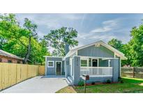 Charming single-story home featuring a welcoming porch and landscaped front yard, showcasing its appealing curb appeal at 3910 N Suwanee Ave, Tampa, FL 33603