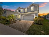 Beautiful two-story home featuring a two-car garage and a manicured front yard with lush landscaping at 4528 Ballantrae Blvd, Land O Lakes, FL 34638