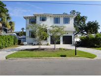 Inviting two-story home with a well-manicured lawn and a two-car garage at 5009 W Longfellow Ave, Tampa, FL 33629