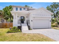 Beautiful two-story home with white stucco, black accents, two car garage and inviting curb appeal at 7113 S Kissimmee St, Tampa, FL 33616