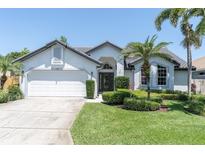 Charming single-story home featuring lush landscaping and a well-manicured lawn at 865 Live Oak Ne Ter, St Petersburg, FL 33703
