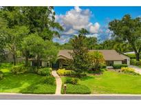 Charming single-story home with lush landscaping, stone accents, and a well-manicured front yard at 1007 Morfield Ln, Brandon, FL 33511