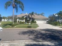 Charming single-story home with mature landscaping and a two-car garage at 1695 Stable Trl, Palm Harbor, FL 34685