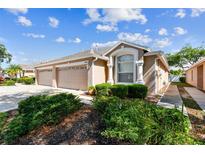 Charming single-story home with a two-car garage, landscaped yard, and a stucco exterior at 31434 Shaker Cir, Wesley Chapel, FL 33543