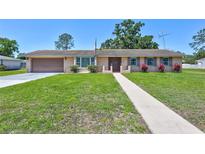Charming single-story home with a well-manicured lawn and a classic design at 403 Cactus Cir, Seffner, FL 33584