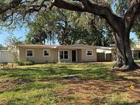 A charming single-story home featuring a spacious front yard and mature trees at 4716 W Vasconia St, Tampa, FL 33629