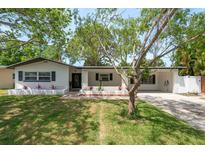Charming single-story home with a well-manicured lawn and inviting front porch at 555 7Th S St, Safety Harbor, FL 34695