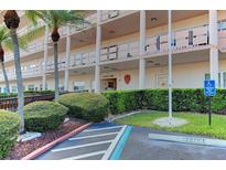 Low angle of the condo building's manicured landscaping and handicap parking space at 5623 80Th N St # 306, St Petersburg, FL 33709