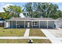 Charming one-story home featuring a lovely front porch and well-maintained landscaping, creating inviting curb appeal at 9653 Golden Grove St, Seminole, FL 33772