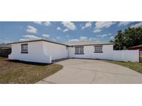 Exterior view of the single-story home showcasing its painted concrete and garage at 1204 Croydonwood Cir, Brandon, FL 33510