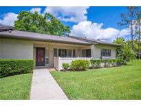 Charming single-story villa with a well-manicured lawn, sidewalk and white picket fence at 150 James Ct, Oldsmar, FL 34677