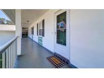 Inviting entrance to unit 205 features a welcome mat and decorative wreath at 200 Glennes Ln # 205, Dunedin, FL 34698