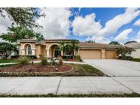 Stunning home with tile roof, mature landscaping, and a three-car garage at 2042 Diamond Ct, Oldsmar, FL 34677