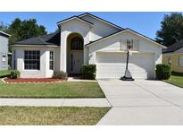 Charming home with a well-maintained lawn, two-car garage, and a basketball hoop at 3414 Berry Blossom Ln, Plant City, FL 33567