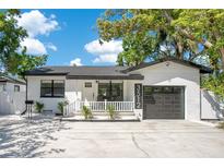Charming single-story home with a well-manicured lawn and a welcoming front porch, perfect for relaxing outdoors at 3512 Haines N Rd, St Petersburg, FL 33704