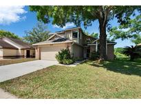 Inviting two-story home with an attached two car garage, driveway and well maintained lawn at 4225 Barret Ave, Plant City, FL 33566