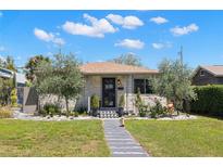 Charming single-story home with a well-manicured lawn, beautiful landscaping, and a welcoming entryway at 4829 20Th N Ave, St Petersburg, FL 33713