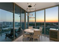Dining room with luxury chandelier has floor to ceiling windows that offer city views at 777 3Rd N Ave # 1408, St Petersburg, FL 33701