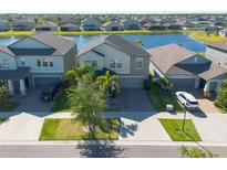 Beautiful two-story home with lush landscaping and a picturesque lake view in a desirable neighborhood at 13639 Ashlar Slate Pl, Riverview, FL 33579