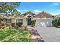 Charming single Gathering home with a two-car garage and well-maintained landscaping at 1518 Rolling Meadow Dr, Valrico, FL 33594