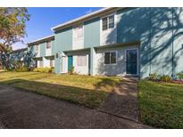 Charming townhome with a well-maintained lawn and a walkway leading to the front door at 195 114Th Ne Ave # 195, St Petersburg, FL 33716