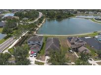 An aerial view showcasing a home's proximity to a serene lake in a well-maintained neighborhood at 20606 Whitewood Way, Tampa, FL 33647
