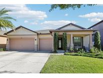 Charming single-Gathering home featuring a three-car garage and well-maintained landscaping at 2127 Landside Dr, Valrico, FL 33594