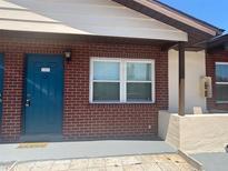 Charming brick exterior with a bright blue door and white window frames at 24862 Us Highway 19 N # 2303, Clearwater, FL 33763