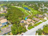 Stunning aerial view of luxury home backing onto lush golf course with solar panels and mature landscaping at 2613 59Th S St, Gulfport, FL 33707