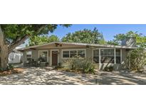 Charming single-story home with a well-maintained lawn, beautiful landscaping, and inviting curb appeal at 2903 W Paxton Ave, Tampa, FL 33611