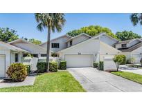 Well-maintained two-story home with a two-car garage and lush landscaping at 486 Lakeview Dr # 54, Palm Harbor, FL 34683