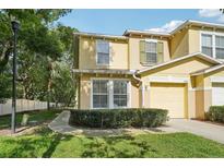Charming two-story townhome with landscaped front yard and attached one car garage at 5302 Aloha Seed Dr, Seffner, FL 33584