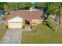 Charming single Gathering home with a well maintained front yard and a driveway leading to a one car garage at 10833 96Th N St, Largo, FL 33773