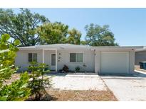 Charming single-story home with a well-maintained front yard and attached one car garage at 1253 Union St, Clearwater, FL 33755