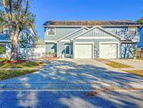 Daytime view of a two-story home with a two-car garage and a spacious driveway at 16819 Stanza Ct, Tampa, FL 33624