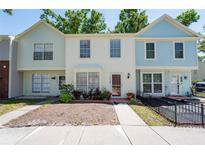Charming townhome with a well-maintained exterior, neat landscaping, and inviting front porch at 1728 Mill Run Cir, Tampa, FL 33613
