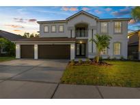 Charming two-story home with a well-manicured lawn and a spacious three-car garage at 17917 Machair Ln, Land O Lakes, FL 34638