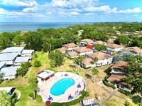 Aerial view of a home and the community pool, showcasing its location and surrounding greenery at 1821 Bough Ave # 4, Clearwater, FL 33760