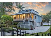 Beautiful two-story home with a charming porch and a well-manicured lawn, perfect for waterfront living at 2314 N Riverside Dr, Tampa, FL 33602
