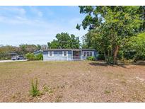 Charming single-story home featuring a cozy front porch, well-shaded by mature trees and natural landscaping at 2805 Olavet Ct, Valrico, FL 33596