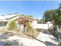 Charming single-story home featuring a fenced yard, walkway, and driveway at 2903 N 16Th St, Tampa, FL 33605