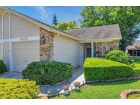 Charming home with a well-manicured lawn and inviting walkway leading to the front entrance at 6428 Remus Dr, New Port Richey, FL 34653