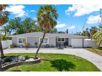 Charming single-story home with a well-manicured front yard and a large palm tree at 7800 Causeway N Blvd, St Petersburg, FL 33707