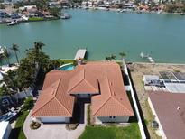 Stunning waterfront property with a private pool, dock, and lush landscaping at 8053 13Th S Ave, St Petersburg, FL 33707