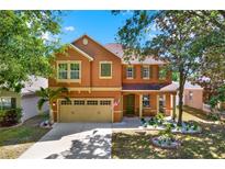 Charming two-story home featuring a well-maintained front yard with decorative landscaping and a welcoming entrance at 11118 Running Pine Dr, Riverview, FL 33569