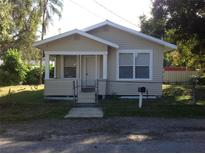 Charming single-story home with a small porch, fenced yard, and well-maintained lawn on a sunny day at 2217 N 64Th St, Tampa, FL 33619