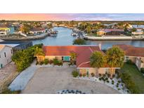 Beautiful waterfront home with lush landscaping, private dock, and stunning sunset views at 4968 Southshore Dr, New Port Richey, FL 34652
