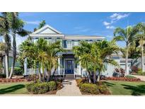 Charming coastal home with lush landscaping and a welcoming front porch perfect for relaxation at 718 Manns Harbor Dr, Apollo Beach, FL 33572