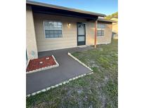 Charming single-story home with a welcoming front entrance and well-maintained landscaping at 7601 Como Dr, New Port Richey, FL 34655